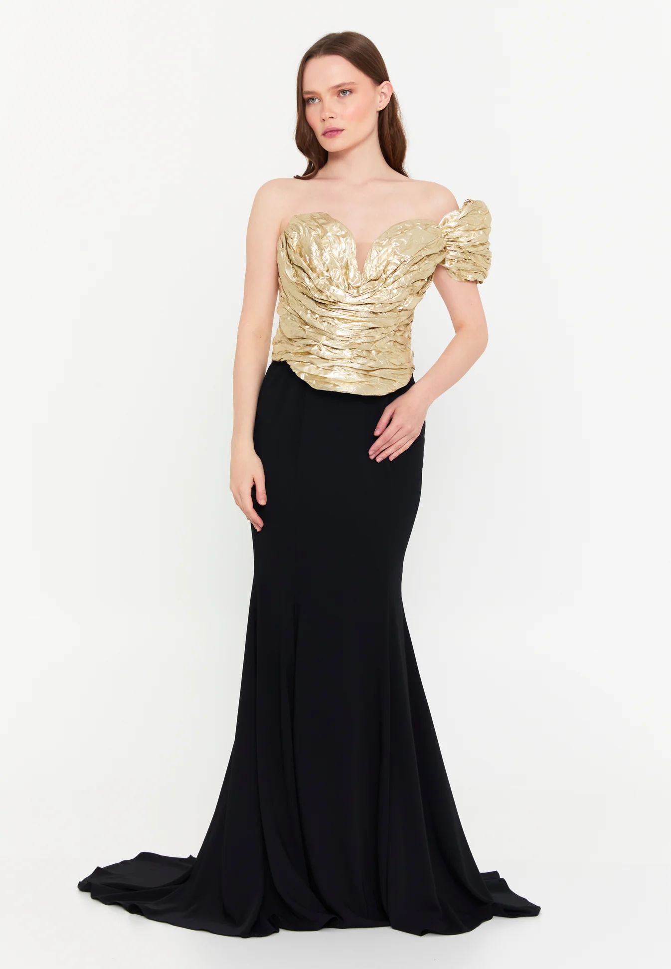Woman in elegant gold and black gown