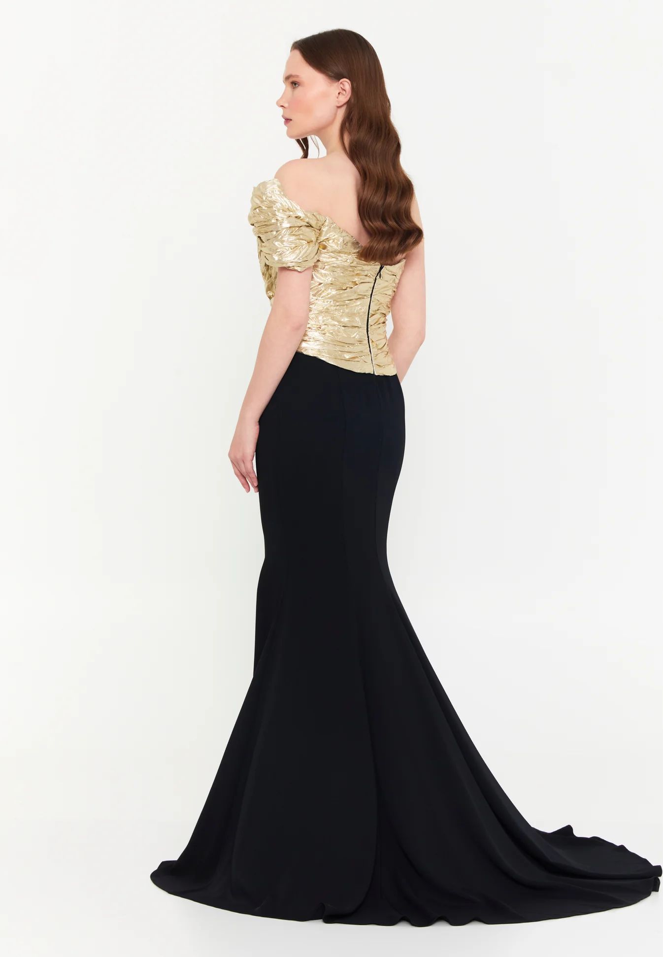 Woman in elegant gold and black gown