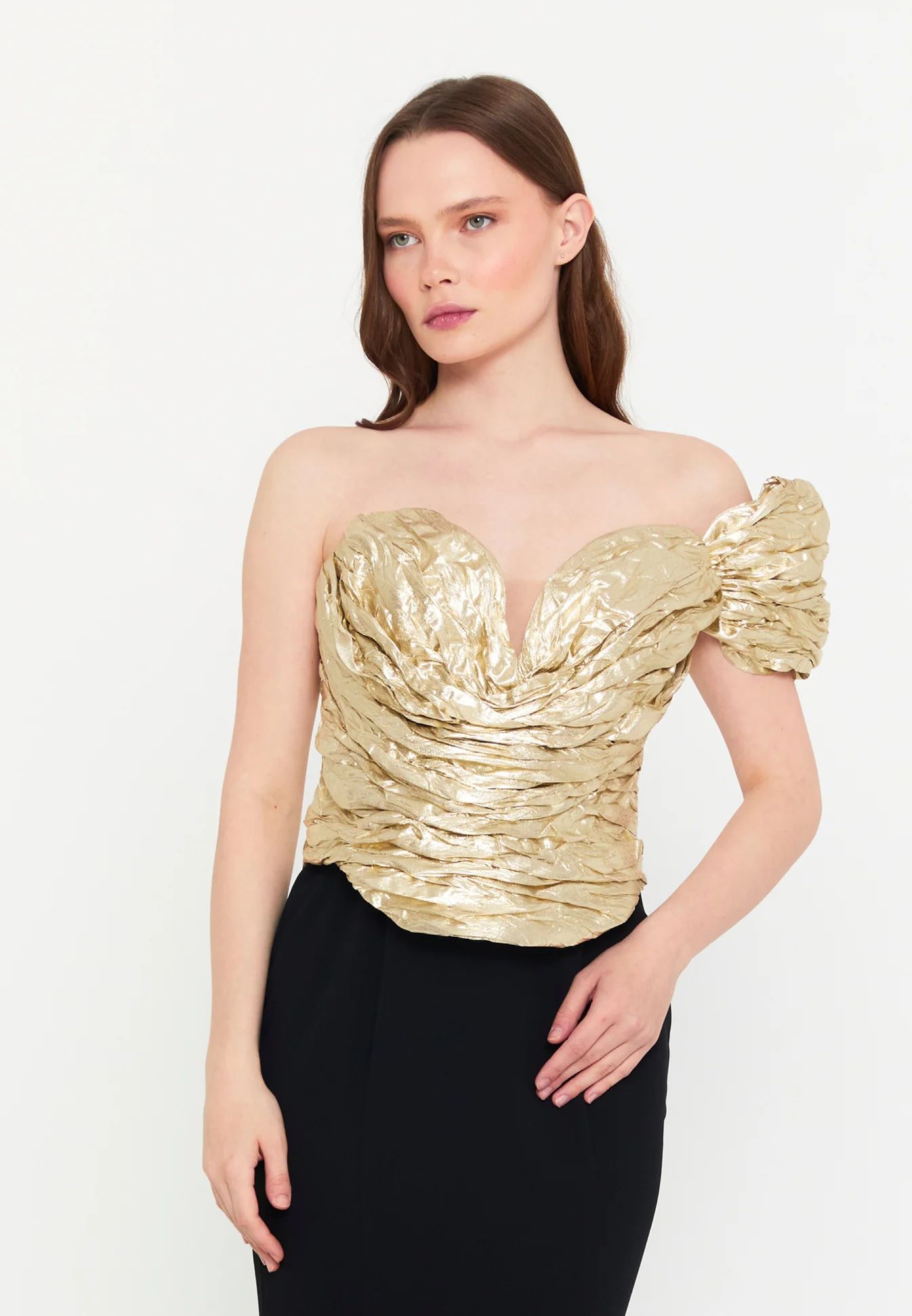 Woman in elegant gold and black gown