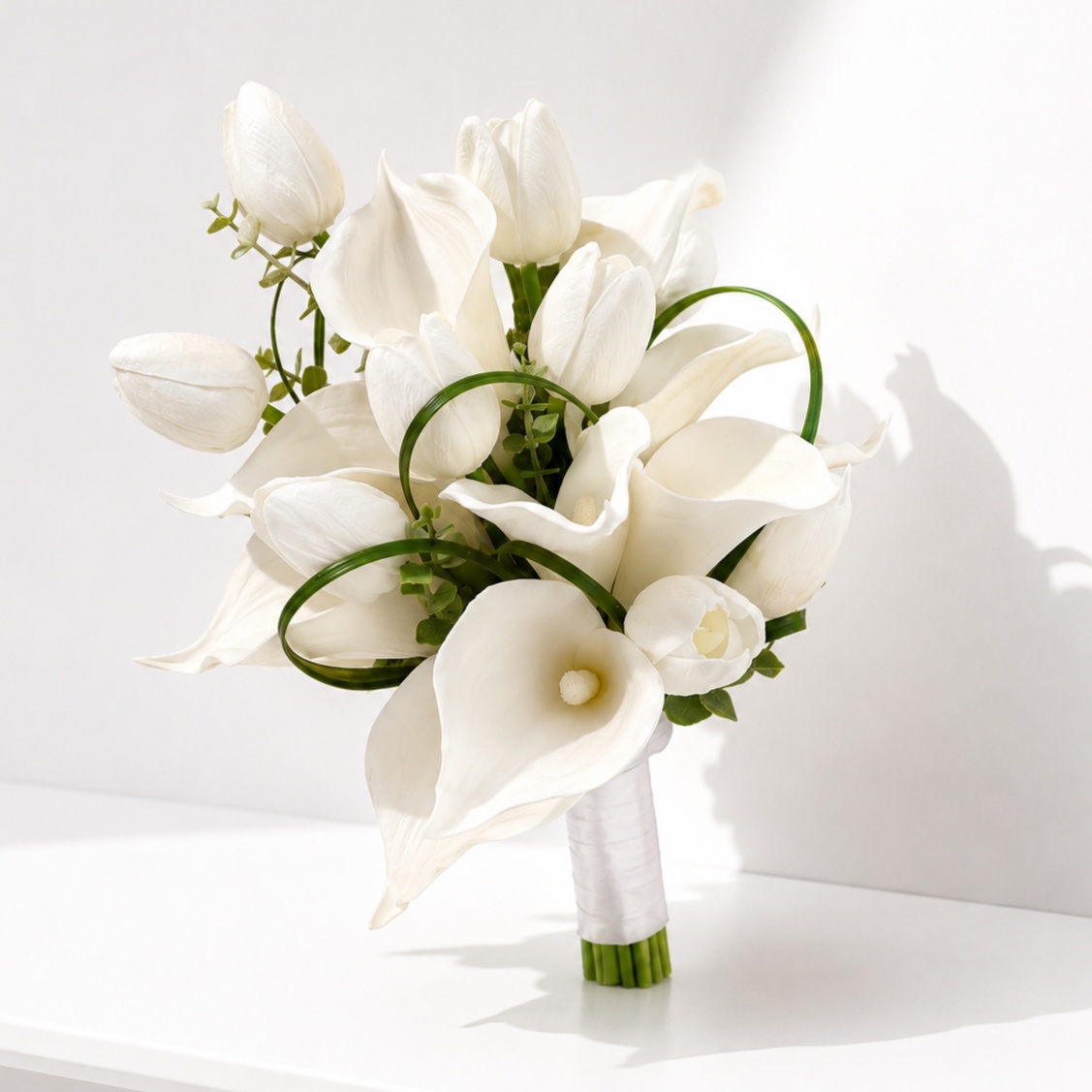  Luxury bridal bouquet featuring white calla lilies and white tulips in a modern elegant arrangement, perfect for weddings.
