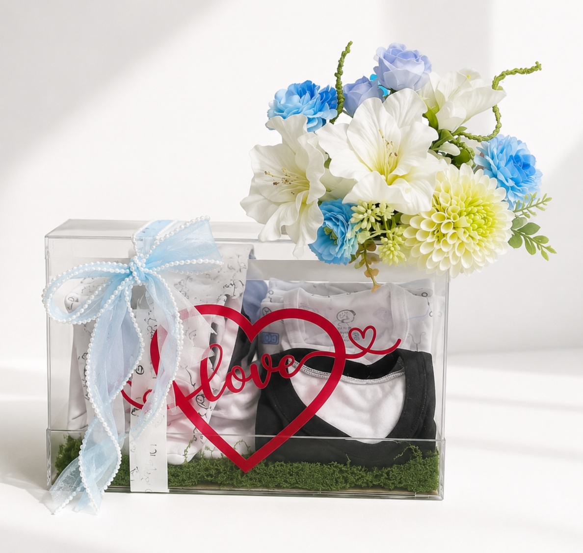 Luxury acrylic baby boy gift box with newborn clothes and fresh white and blue flowers
