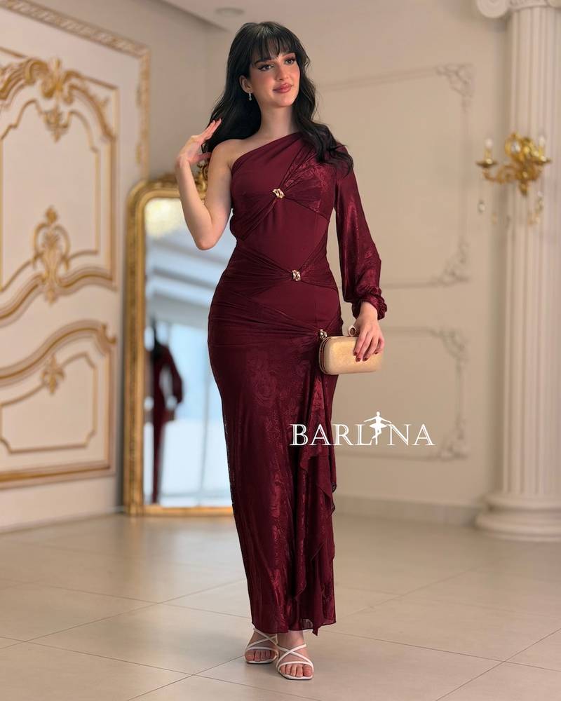A soft, fitted dress adorned with elegant metallic details.