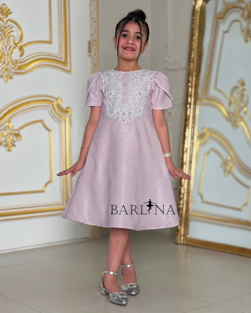 Light mauve girls' dress with white patterns on the chest