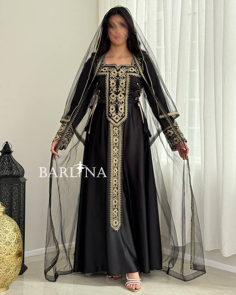 Black jalabiya with gold embroidery and a sheer headscarf