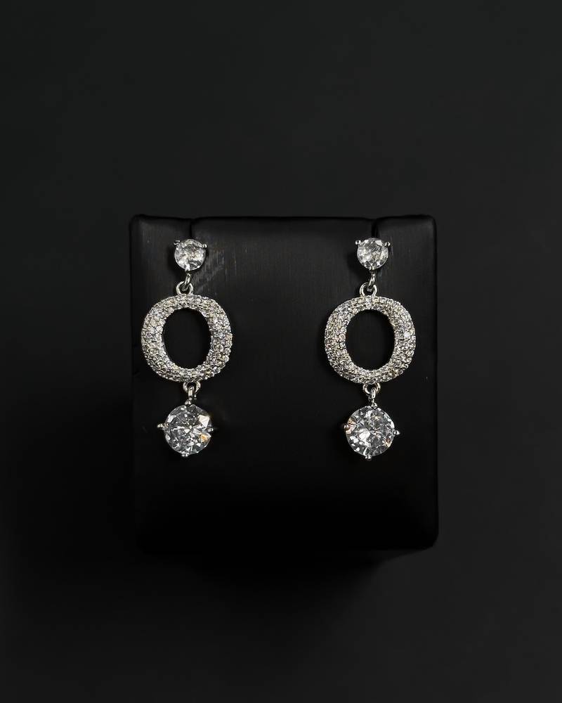 Elegant silver hoop earrings with a round, studded design