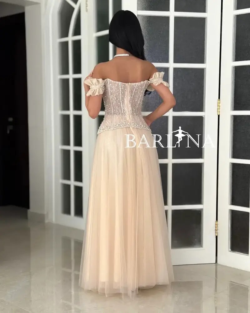 Beige evening dress with a corset cut and beaded embellishments