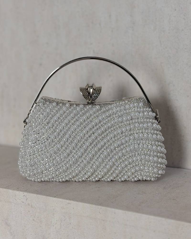 An evening bag adorned with matching pearls