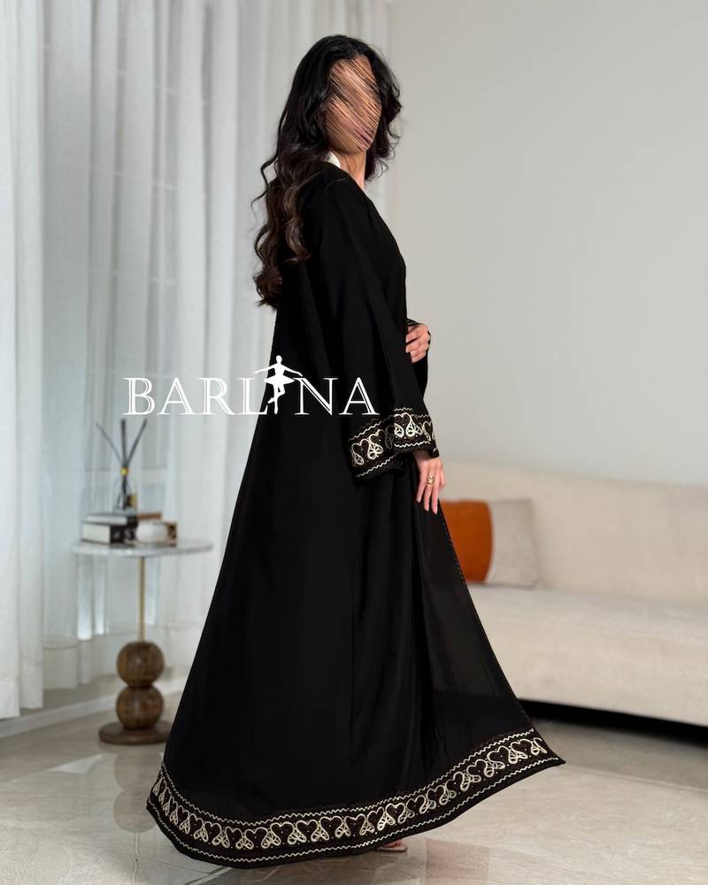 A soft black abaya with prominent beige embroidery