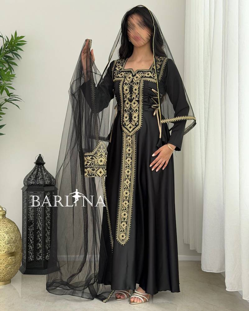 Black jalabiya with gold embroidery and a sheer headscarf
