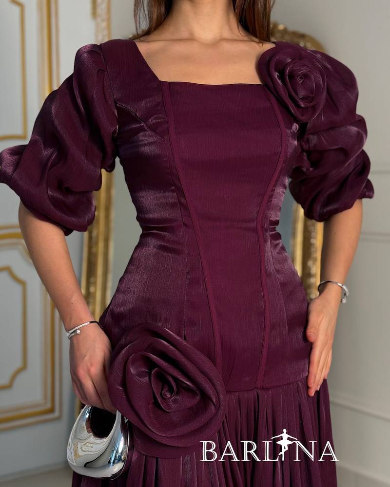 A purple dress adorned with roses and a touch of pleats