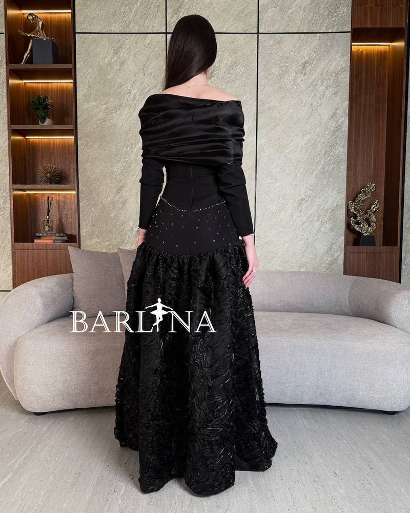 Black dress with prominent fabric and long sleeves