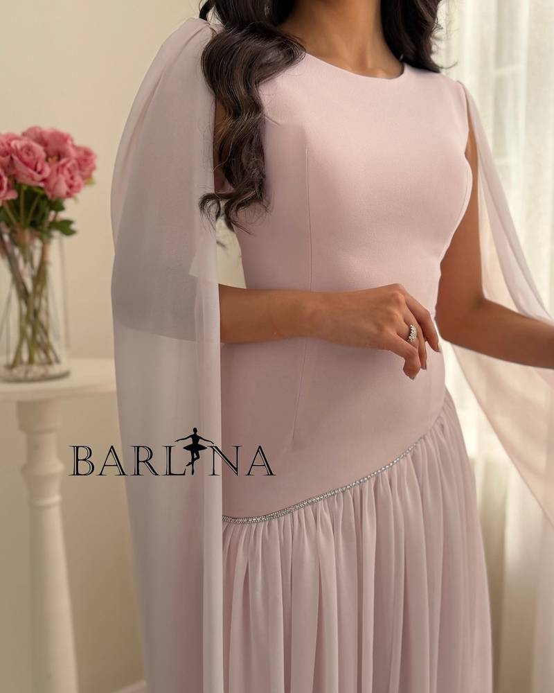 Pastel pink dress with a shawl over the shoulders