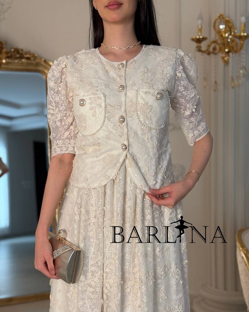 A two-piece off-white dress with an elegant lace design