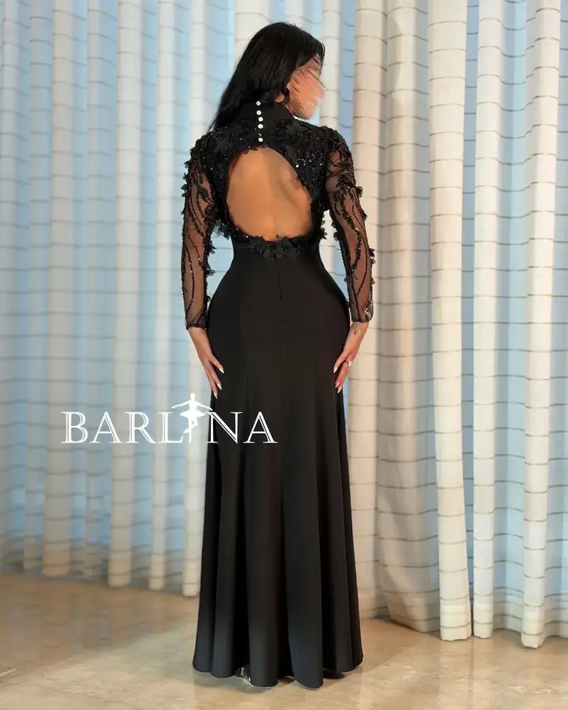 Black dress with sheer sleeves and an open back