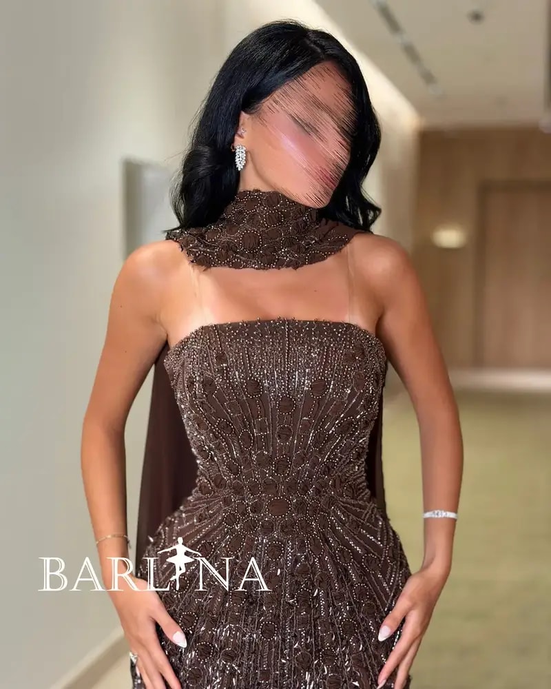 A shimmering brown dress with luxurious details and a shawl