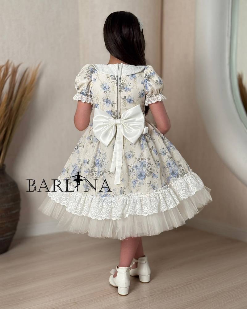 A classic off-white girl's dress with a floral print