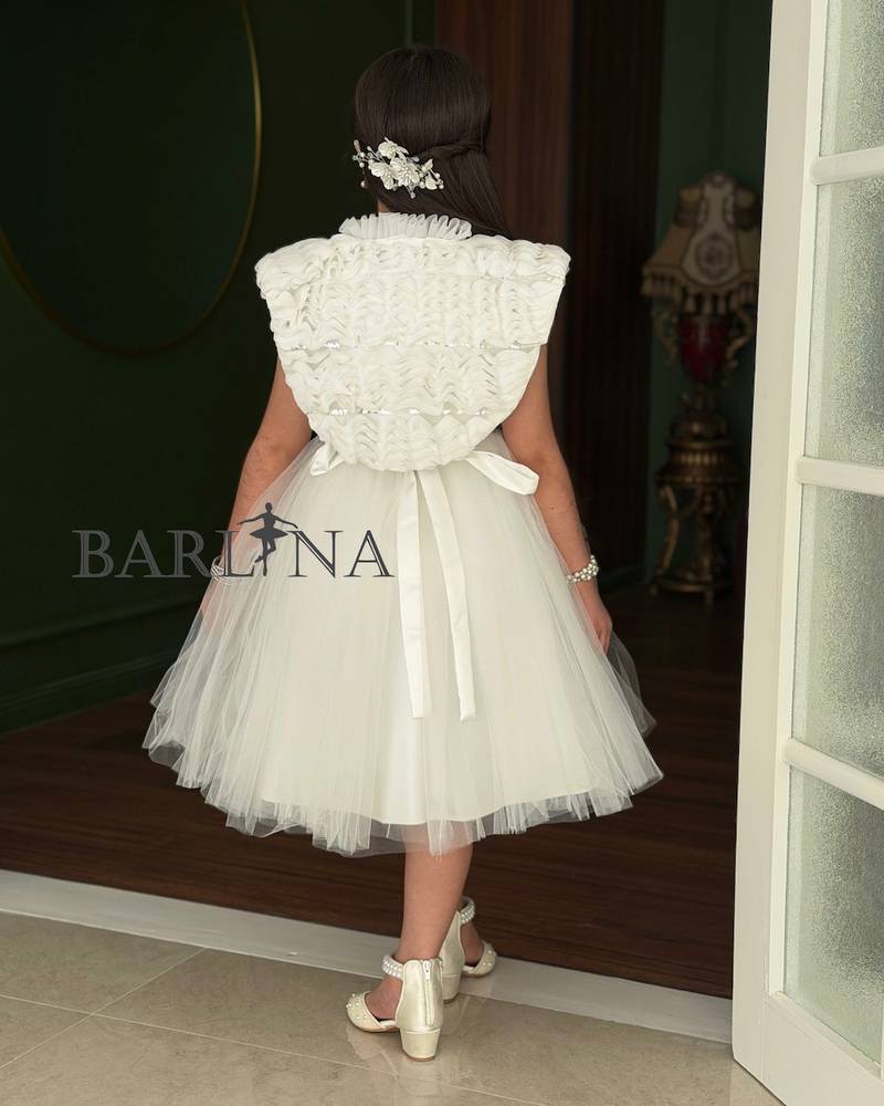 White girl's dress with a large ruffled shoulder