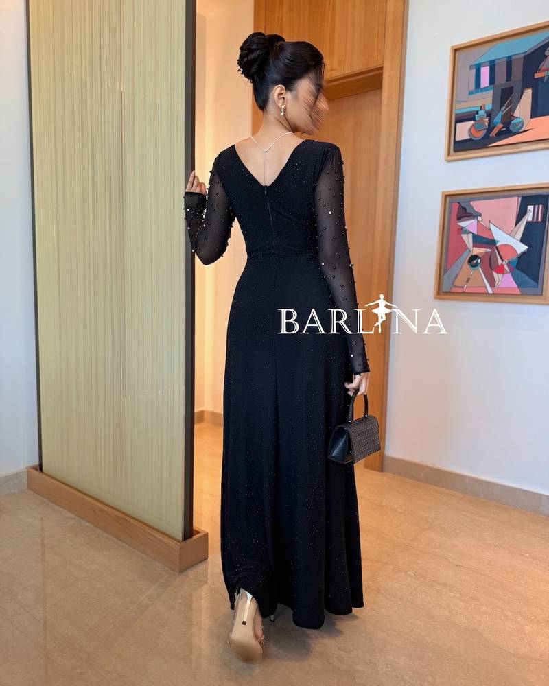 Black dress with long sleeves adorned with pearls