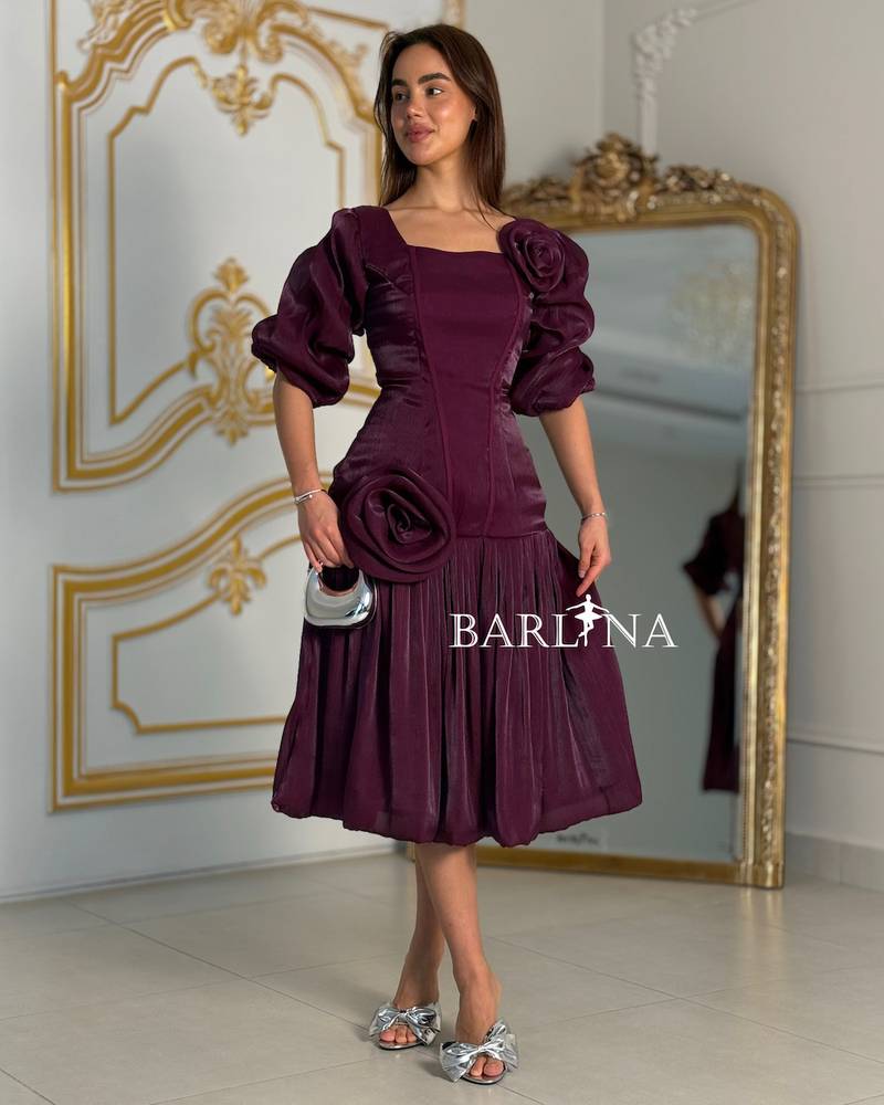 A purple dress adorned with roses and a touch of pleats