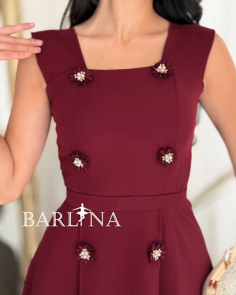 Elegant burgundy dress adorned with striking details