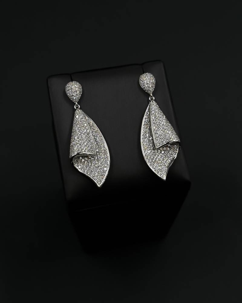 Diamond-studded silver earrings with a twist design