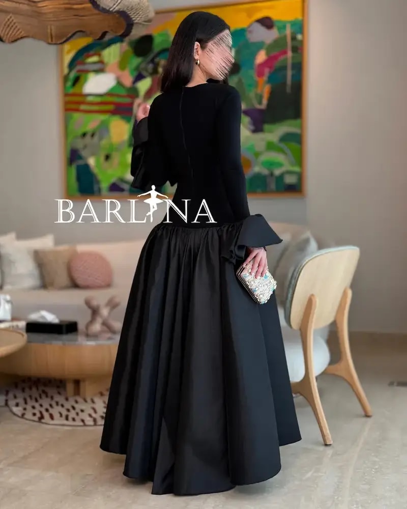 Elegant black dress with a high-cut top and long sleeves