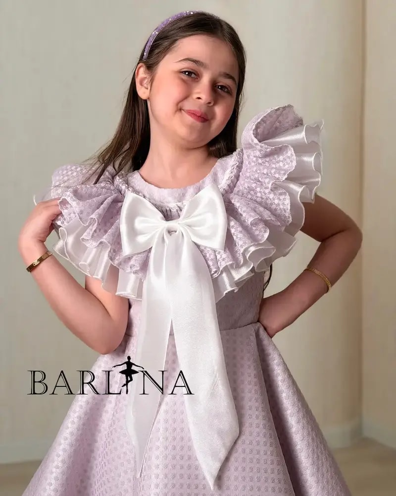 Purple girl's dress decorated with a large bow