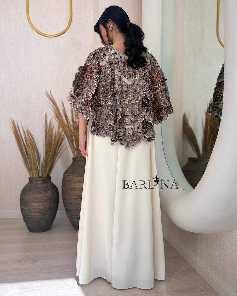 Elegant off-white dress with an embroidered overlay