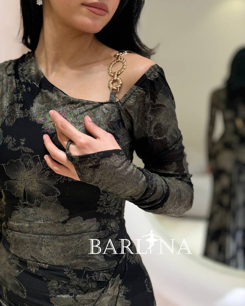 A black dress with an elegant pattern and a fitted silhouette.