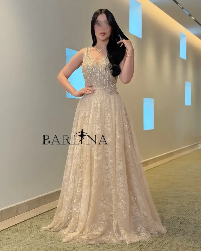 A luxurious flowing beige lace evening dress