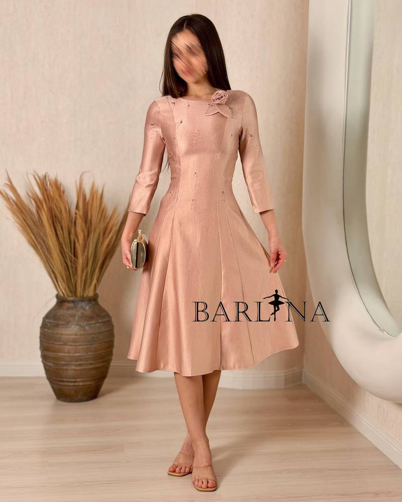 A soft midi dress adorned with a delicate rose