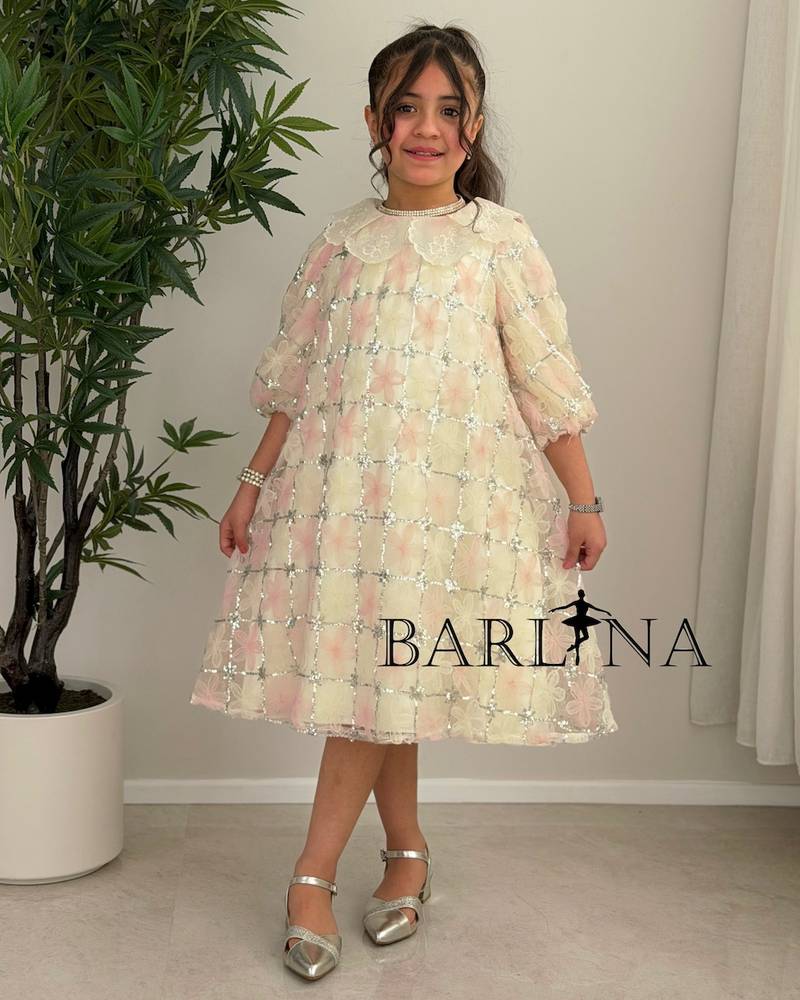 Beige girl's dress decorated with delicate flowers