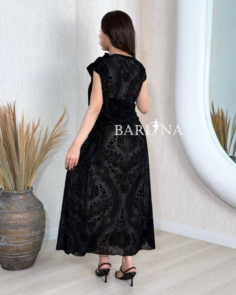 Black dress with an asymmetrical neckline and a slit