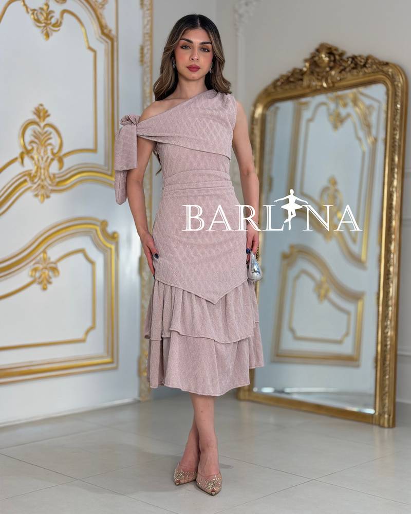 A soft dress with an elegant bow and layered details