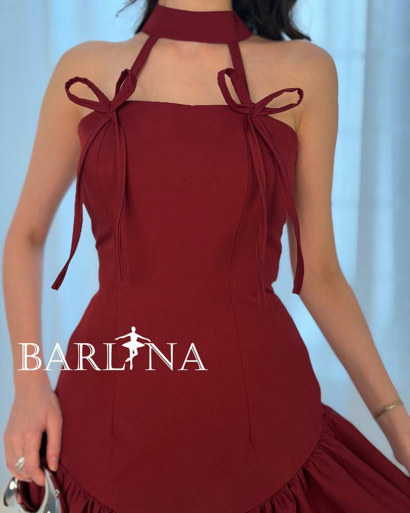 A soft burgundy dress adorned with elegant bows