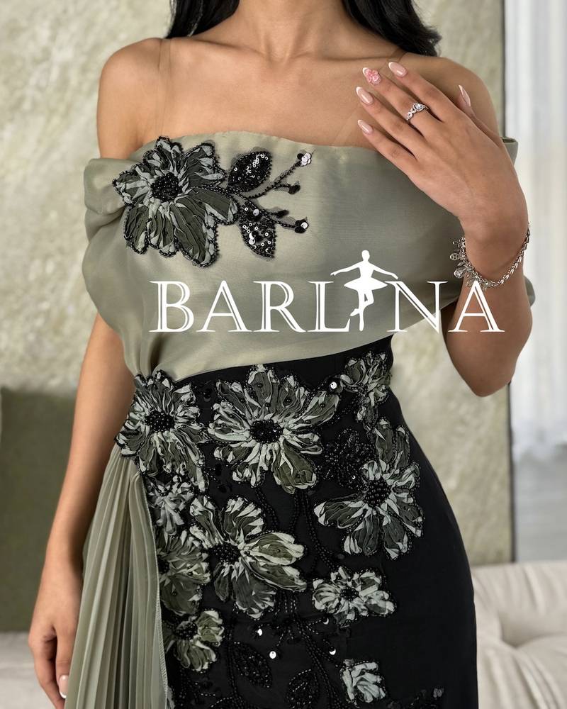 Black dress with an olive top and pleated tail
