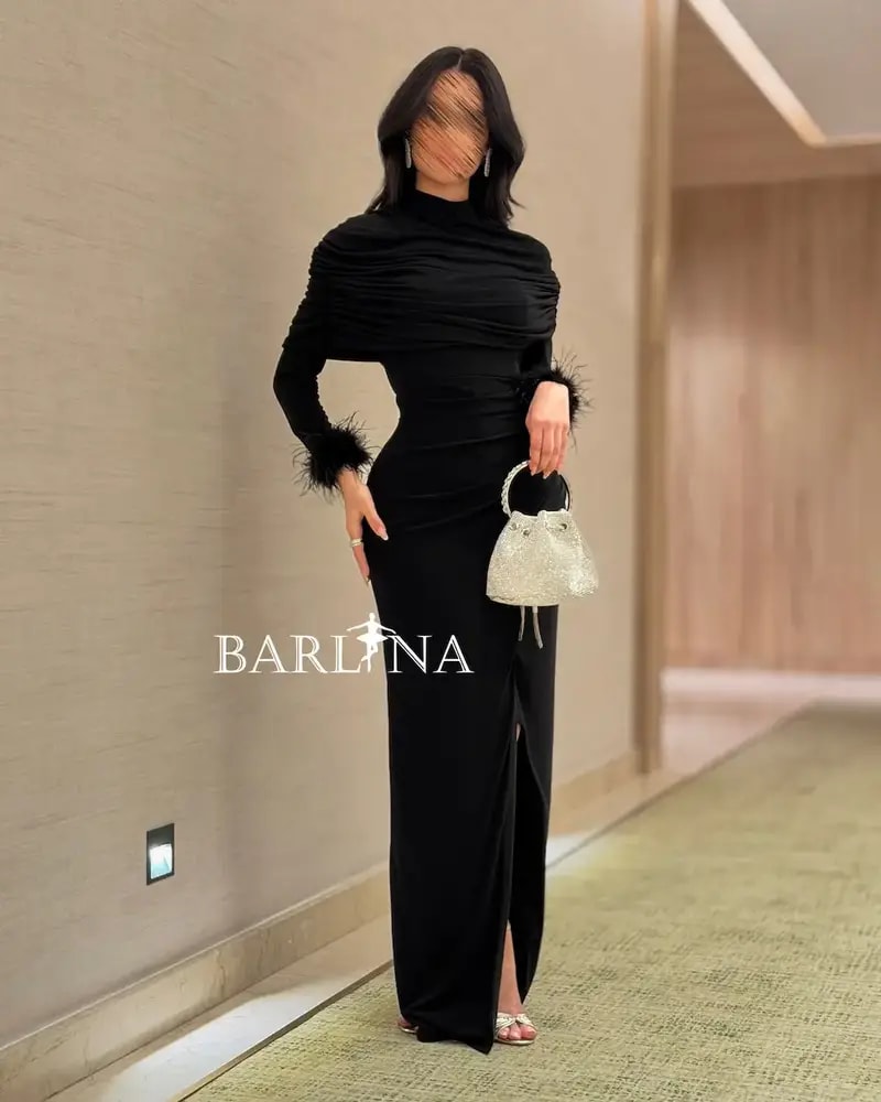Black draped dress with feather-trimmed sleeves