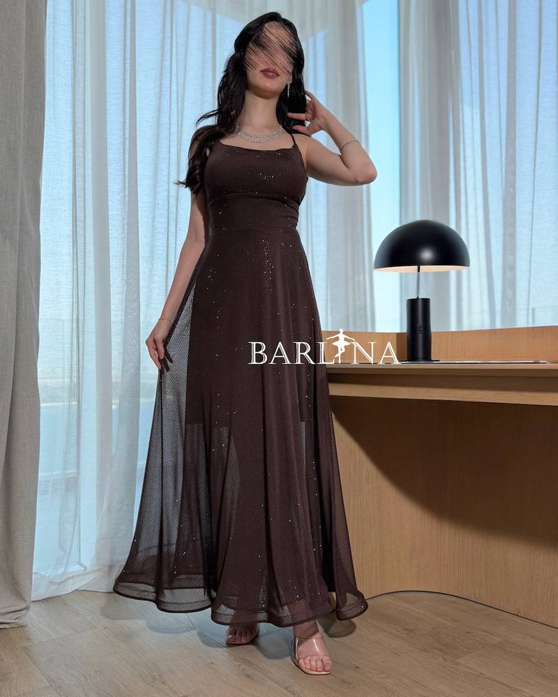 A dark brown sparkly dress with thin straps