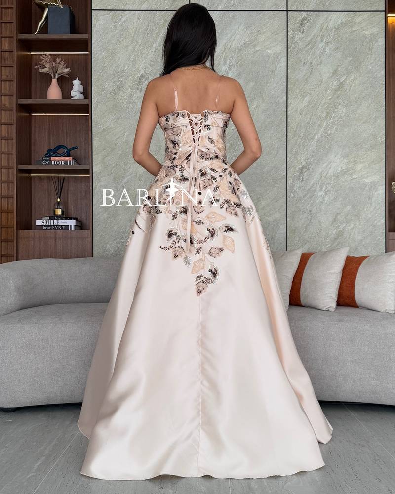 Cream evening dress embroidered with floral motifs