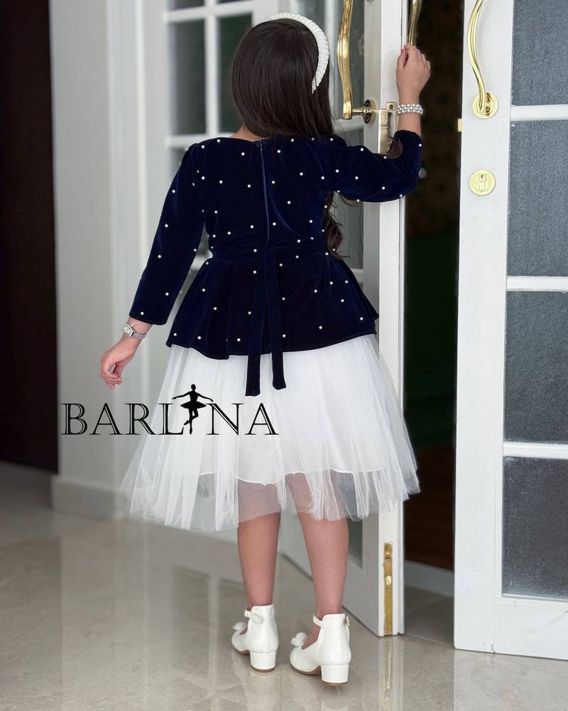 White girl's dress with a navy blue layer and crystals
