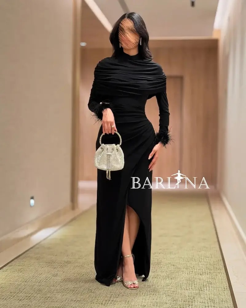 Black draped dress with feather-trimmed sleeves