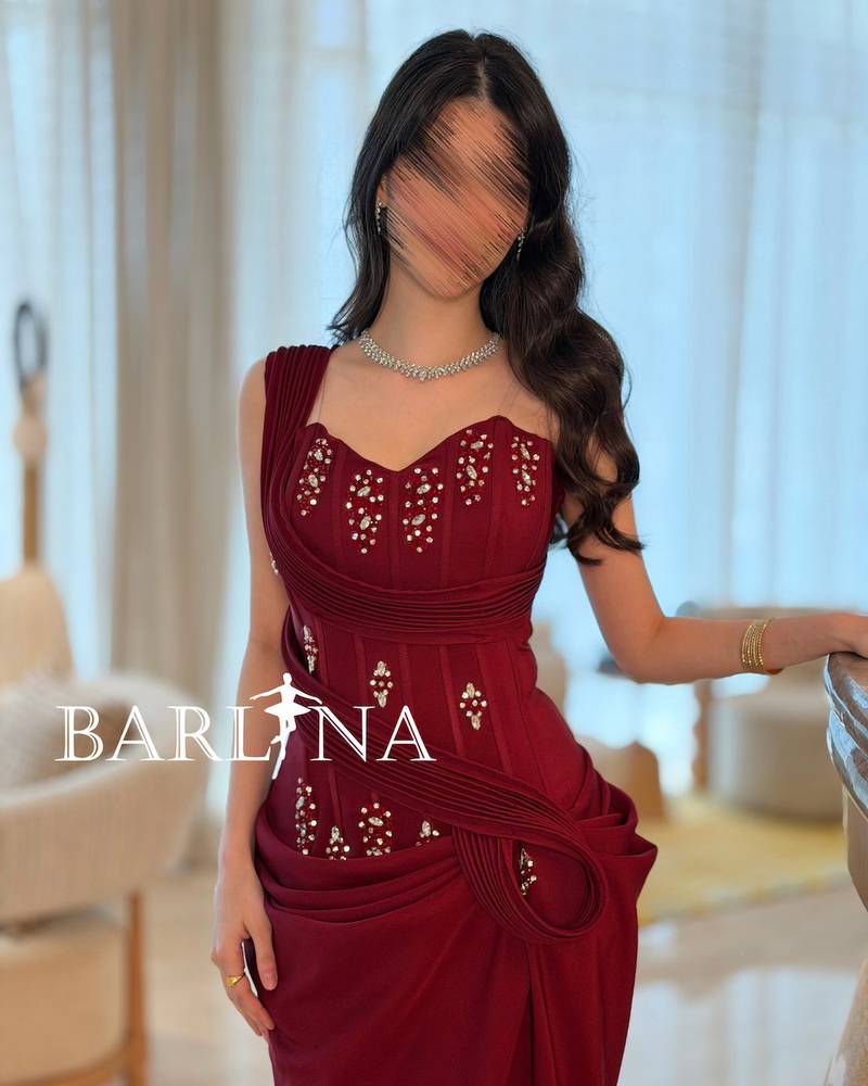 Burgundy dress with shimmering embroidery and draped design