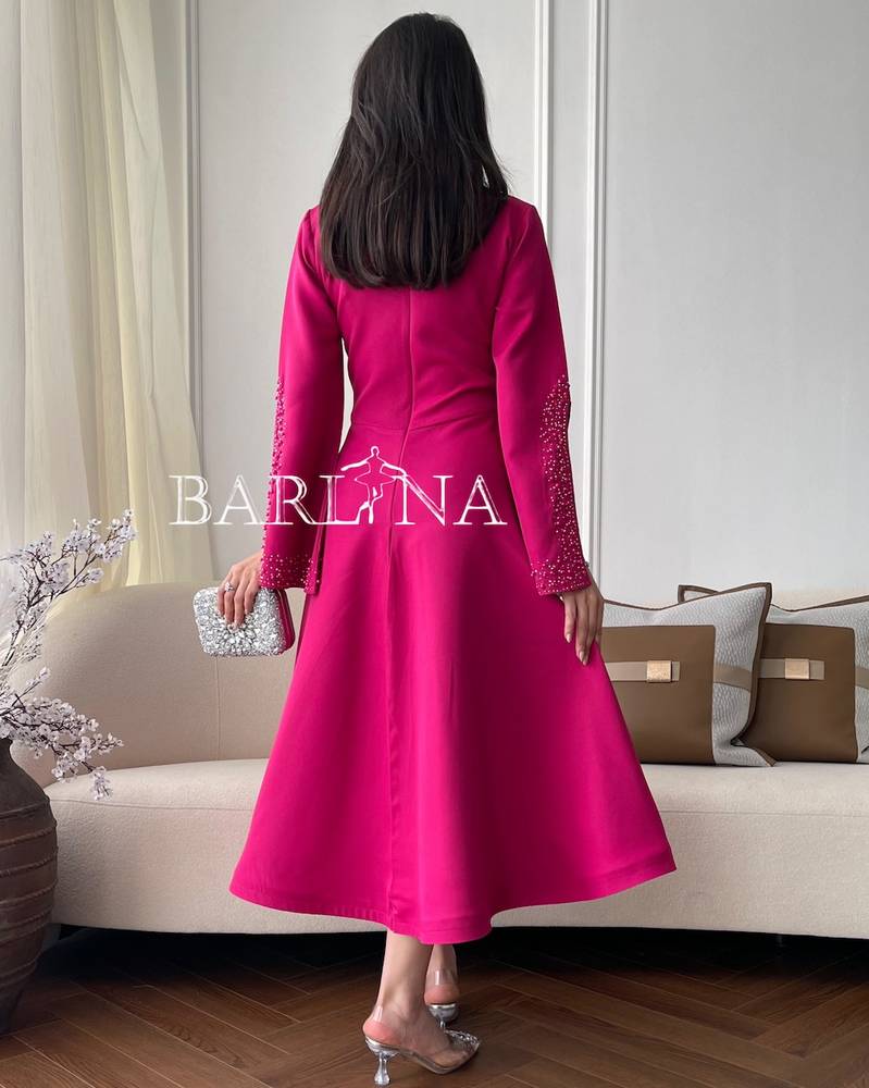 Fuchsia dress with open sleeves decorated with lobes and pearls