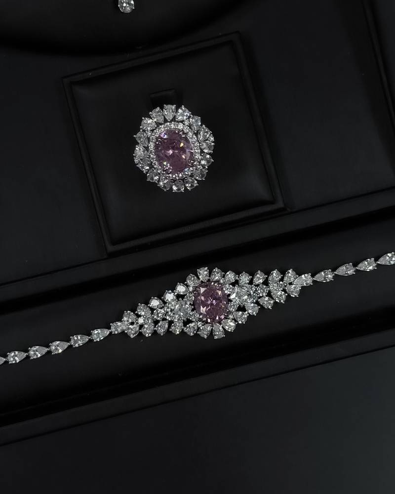 A luxurious accessory set adorned with an elegant pink stone.
