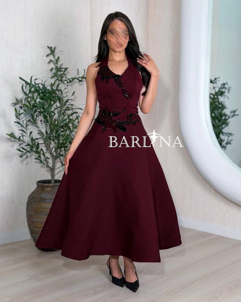 Burgundy evening dress with a wide cut and black embroidery