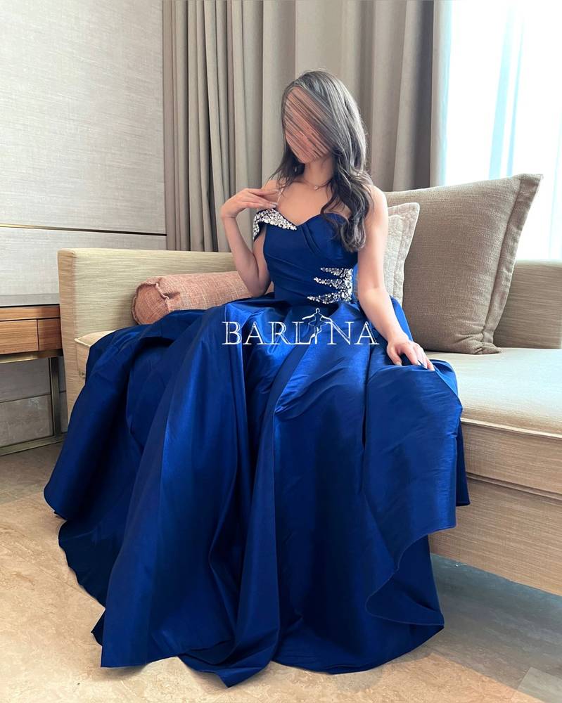 Long blue dress embroidered with crystals