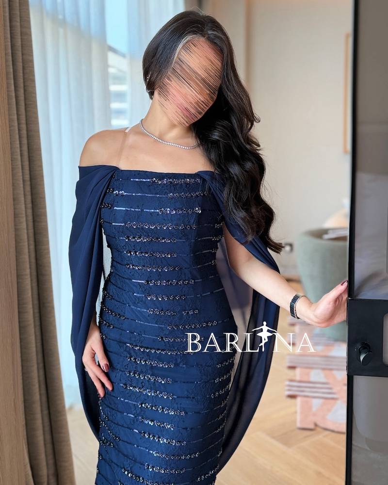 A sparkly navy blue dress with a back cape