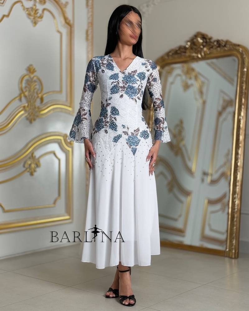 A soft white dress with blue floral embroidery