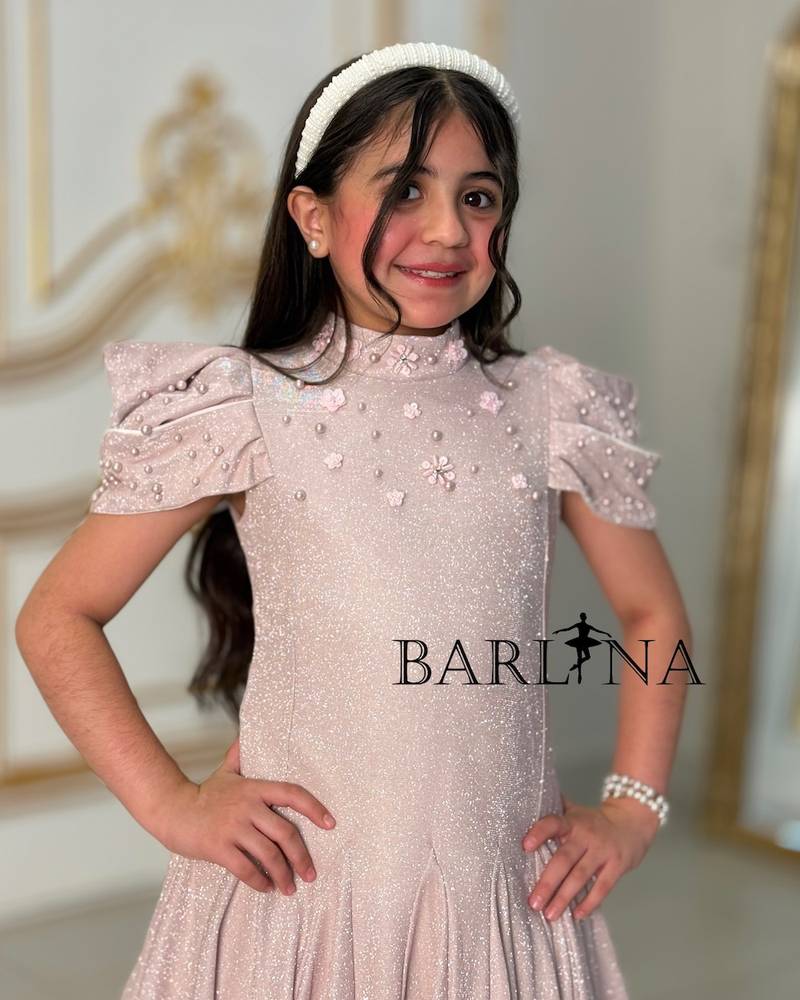 A sparkly girl's dress decorated with pearls