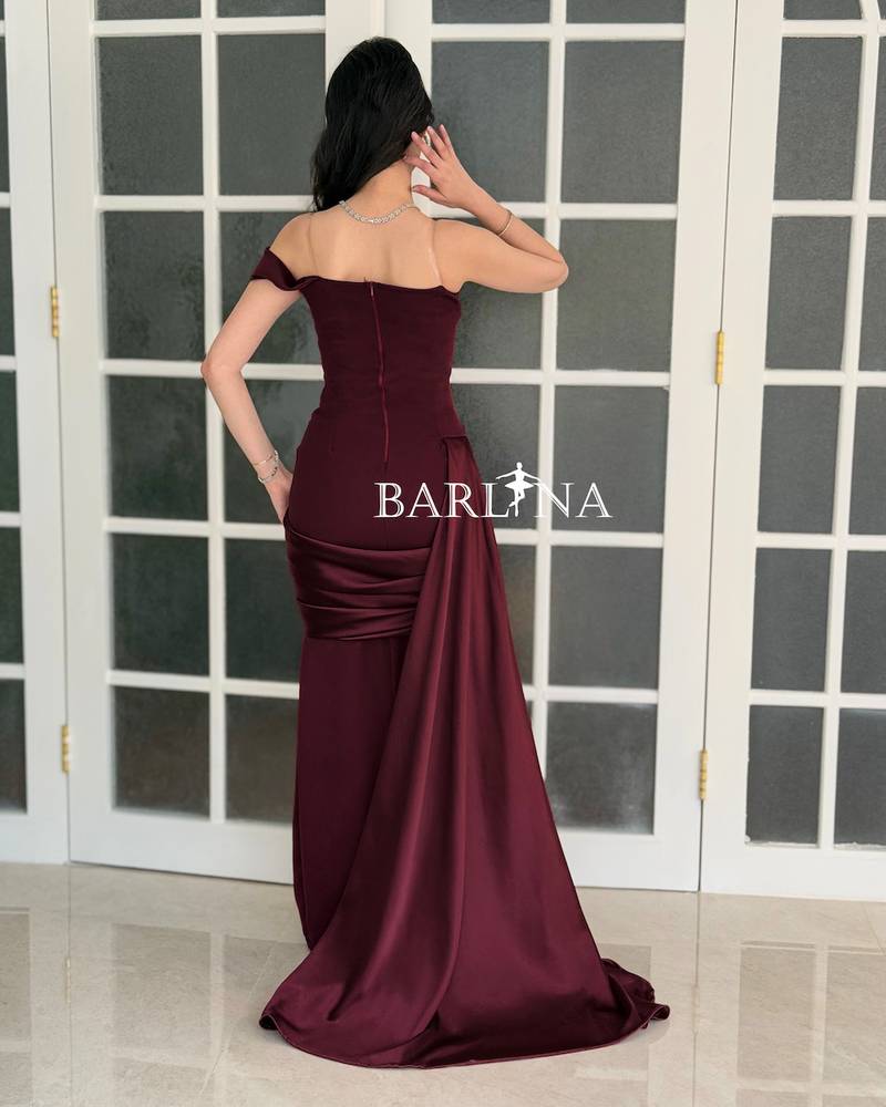 Burgundy dress with side draping and a long train